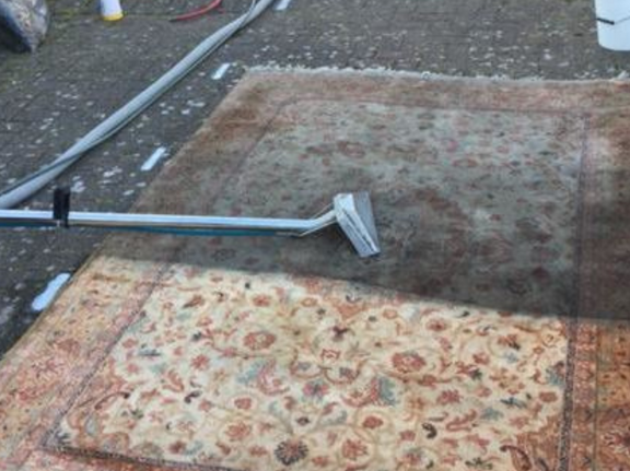 This is a photo of a rug that has been cleaned by K&S Carpet Cleaning, it shows half the rug which has been cleaned, and the other half still requiring cleaning.